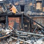 Burned building facade with charred debris