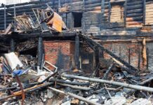 Burned building facade with charred debris