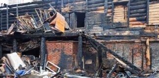 Burned building facade with charred debris