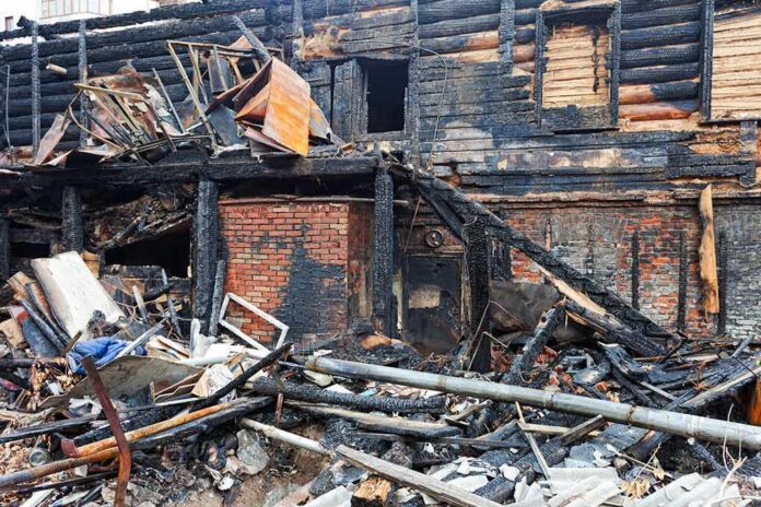 Burned building facade with charred debris
