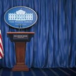 Trump’s Had Enough Of Hegseth, He’s Out Of Order White House press briefing podium with U.S. flag and blue curtain