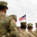 El-Sayed Donor Wants to Dismantle the US Military U.S. flag flying above a formation of soldiers in uniform