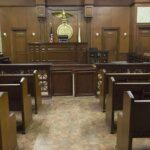 Senator BAILS OUT Boyfriend After Arrest Interior view of an empty courtroom with wooden benches and a judges bench