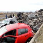 Overturned truck and damaged cars after highway crash
