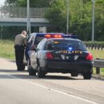 100MPH Police Chase Causes Complete Mayhem Police officer conducting a traffic stop on a highway