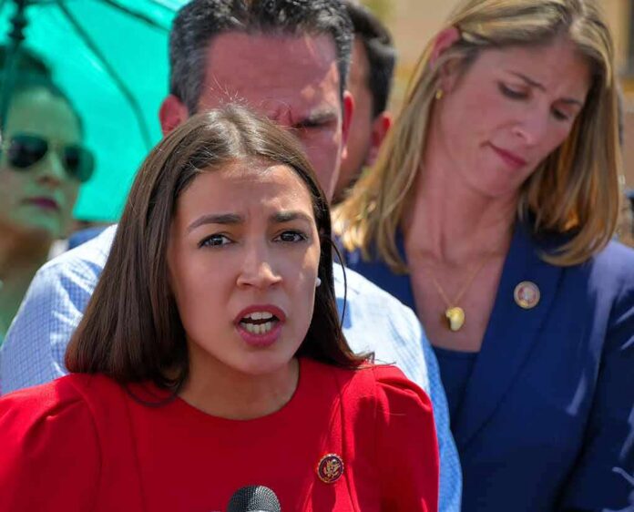 Celines Toribio speaking at an outdoor event with people standing behind her