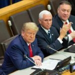 Former Rep MTG Says Trump To NUKE Iran Soon three men in suits seated at a conference table