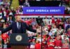 Crowd at a political rally with a speaker at a podium; Stephen Paea, Curtis Lofton, Walter Jones, John Sullivan, and Colin David Jones present