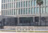 Embassy building behind tall black security fence
