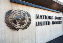 UN Map Vote Sparks U.S. Backlash United Nations emblem and signage on a concrete wall