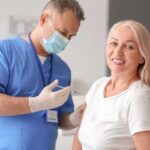 RFK Accused Of Giving False Testimony During Confirmation Hearing Smiling woman receiving a vaccination from a healthcare worker