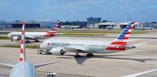 American Airlines jets taxi at a busy airport apron