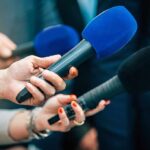 Bipartisan Gamble – Dem Candidate PICKS GOP Mayor As Running Mate Reporters holding colorful microphones