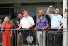 Republican Senator Breaks Ranks, Calls for Probe Into Don Jr Eric Trump, Tucker Carlson, and Donald Trump Jr. on a balcony at a golf club event