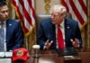 Donald Trump speaks at a meeting beside Marco Rubio at a conference table