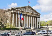 Neoclassical building with columns and French flags