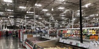 Supermarket dairy aisle with refrigerated cheese display cases