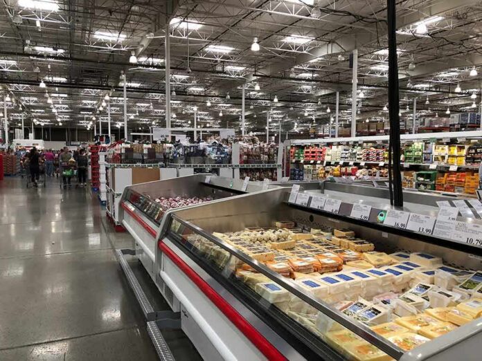 Supermarket dairy aisle with refrigerated cheese display cases