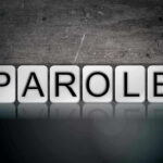 Blocks spelling PAROLE on grungy background.