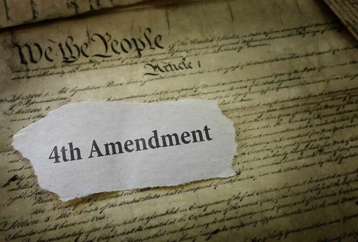 Fourth Amendment text on torn paper over the U.S. Constitution