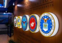 Military department seals displayed on a wall
