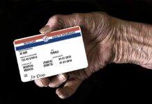 Phony Doctor El-Sayed Continues Lying About His Medicare for All Scheme Elderly hand holding a health insurance card