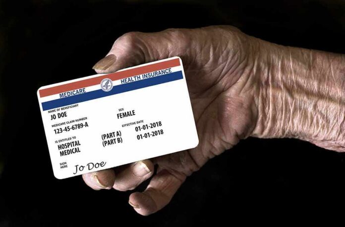 shutterstock_1206430648 Elderly hand holding a health insurance card
