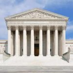 SCOTUS Justice Hints at Exit – Trump Eyes Replacement Front view of the Supreme Court building with large columns and steps under a blue sky