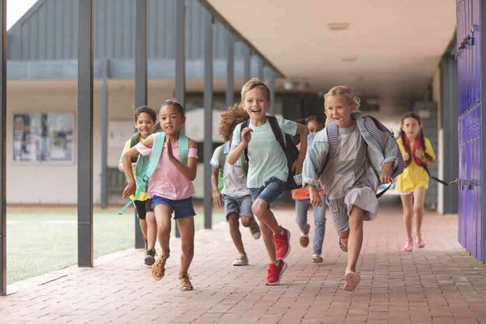 Group of schoolchildren running down a hallway