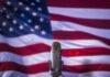 Microphone in front of an American flag backdrop
