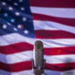 Microphone in front of an American flag backdrop