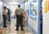 Desperate Manhunt Underway – Convicted Killer Escapes! Corrections officers escort an inmate in a jail hallway