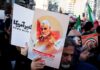 Protesters holding posters of Qasem Soleimani and Abu Mahdi al-Muhandis