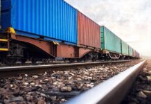 South Africa Cuts ALL U.S Trade, Deals Heavy Blow Freight train with colorful shipping containers on railway tracks
