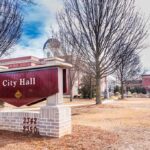 City Hall sign in front of a red-brick municipal building