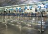 Airport check-in counters with empty queue barriers