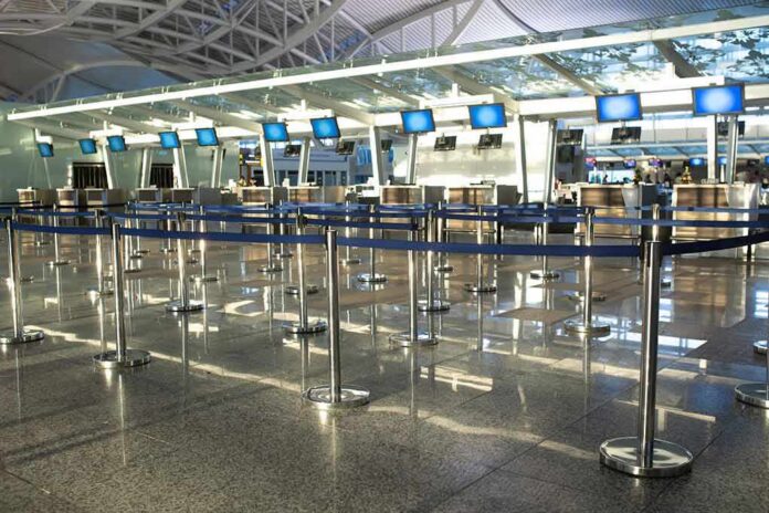 Airport check-in counters with empty queue barriers