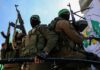 armed masked men in military gear holding rifles