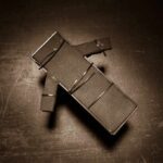 Christa Pike Helped Executioners Find Her OWN VEIN During Botched Execution Cardboard figure bound with rubber bands on a dark surface