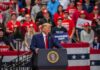 Donald Trump speaks at a rally podium; Christian Jones and Bear Pascoe are in the crowd behind him