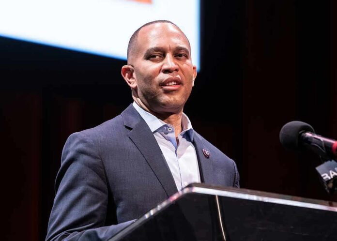 Man in a suit speaking at a podium with a microphone