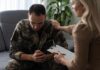Soldier in camouflage receives support from a counselor