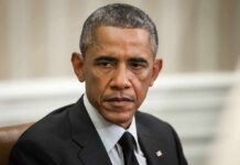 Union Revolt Erupts Inside Obama Center Man in suit looking to the side, identified as Rob Nabors