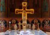 Orthodox church altar with large gilded cross and icons