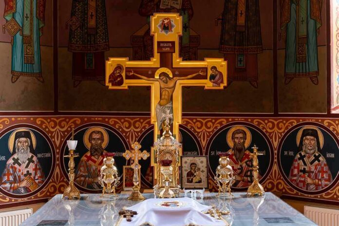 Orthodox church altar with large gilded cross and icons