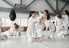 martial arts students practicing grappling in a dojo