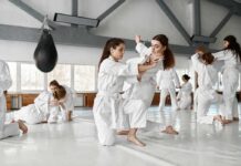 martial arts students practicing grappling in a dojo