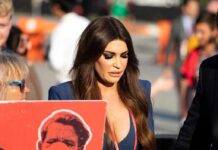 Kimberly Guilfoyle walking outdoors among a crowd