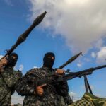 Armed militants in camouflage with rocket launchers and a machine gun