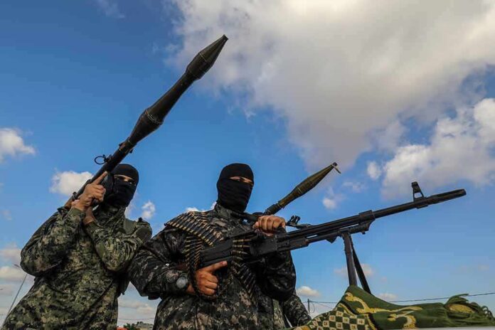 Armed militants in camouflage with rocket launchers and a machine gun